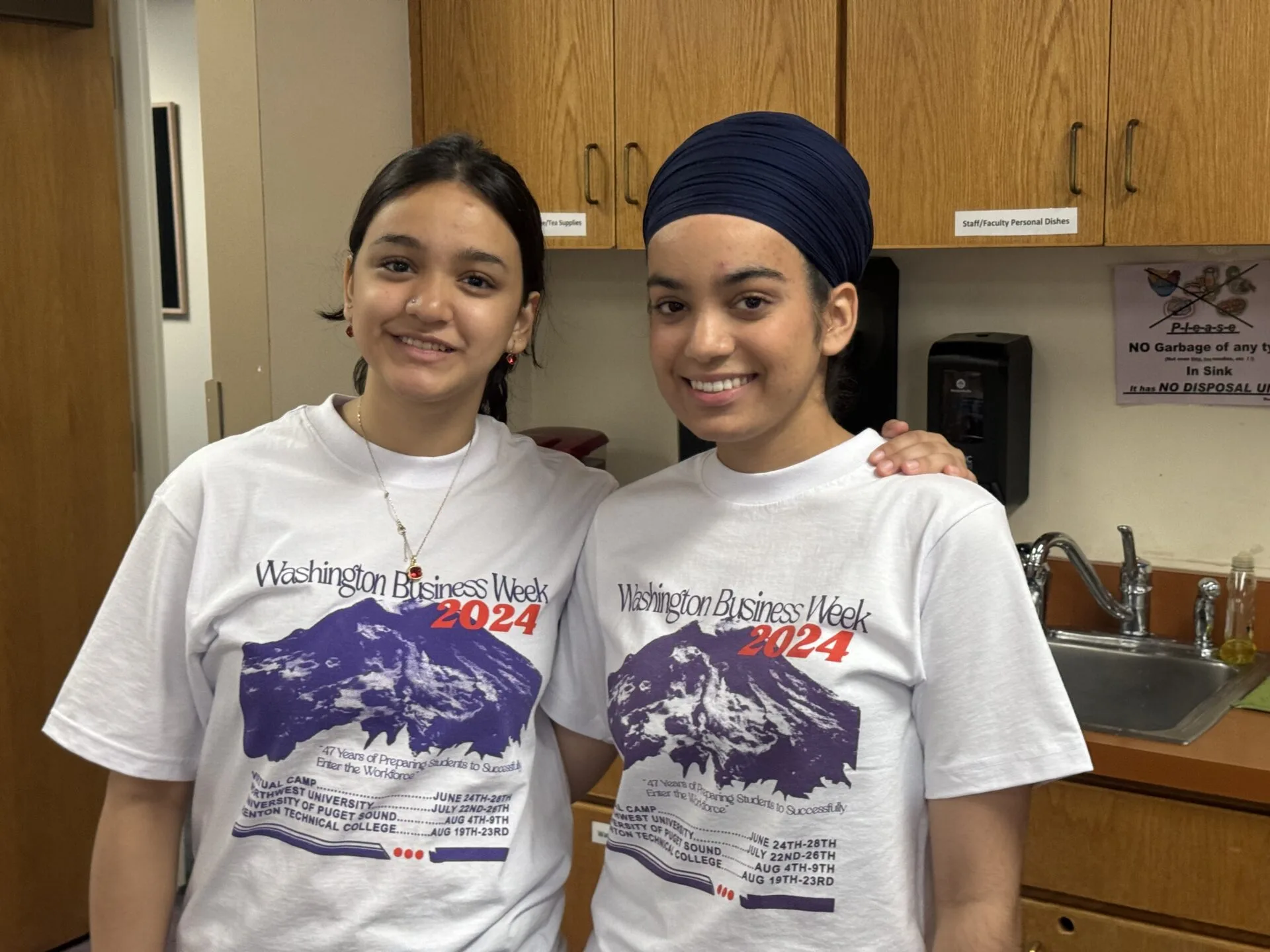 2024 Students Two girls stand posing in WBW shirts.